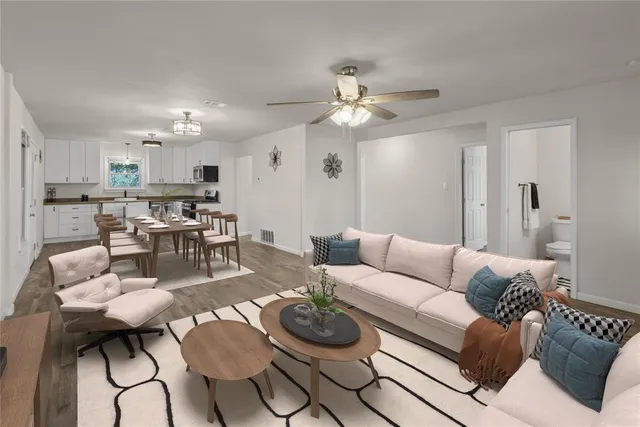 a living room with furniture and kitchen view