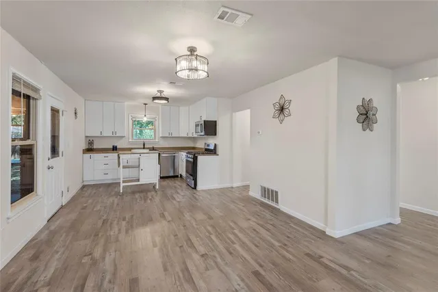 a view of a kitchen with microwave and cabinets