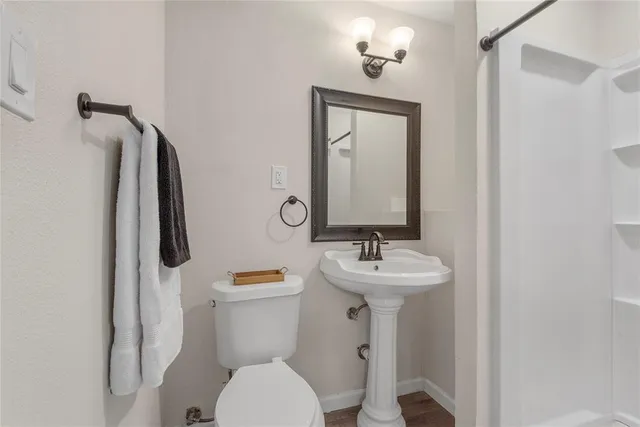 a bathroom with a toilet sink and mirror