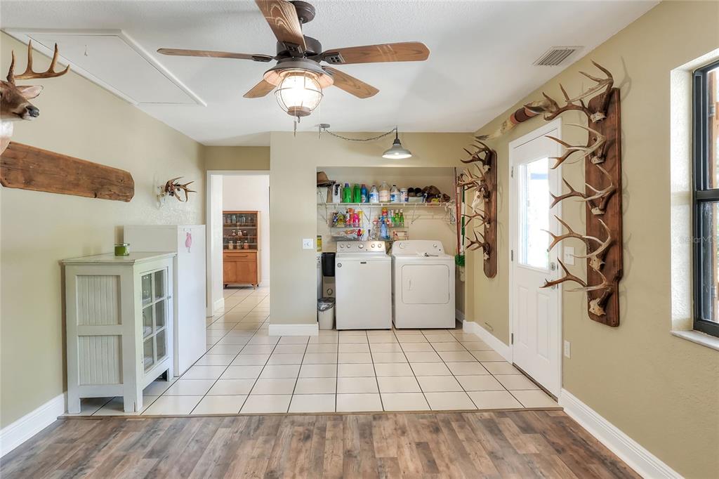 4846 Knights Station Road Lakeland, FL 33810 - Photo 12 of 49 a view of a livingroom with wooden floor and a ceiling fan
