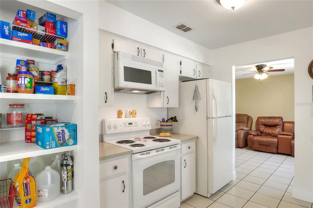 4846 Knights Station Road Lakeland, FL 33810 - Photo 19 of 49 a kitchen with stainless steel appliances a refrigerator and a stove top oven