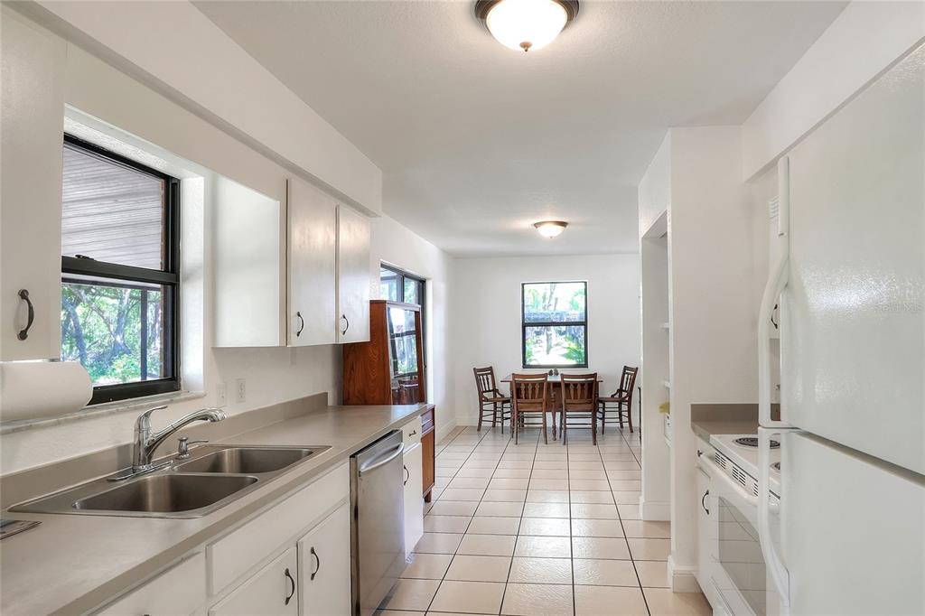 4846 Knights Station Road Lakeland, FL 33810 - Photo 20 of 49 a kitchen with a sink chairs and entryway