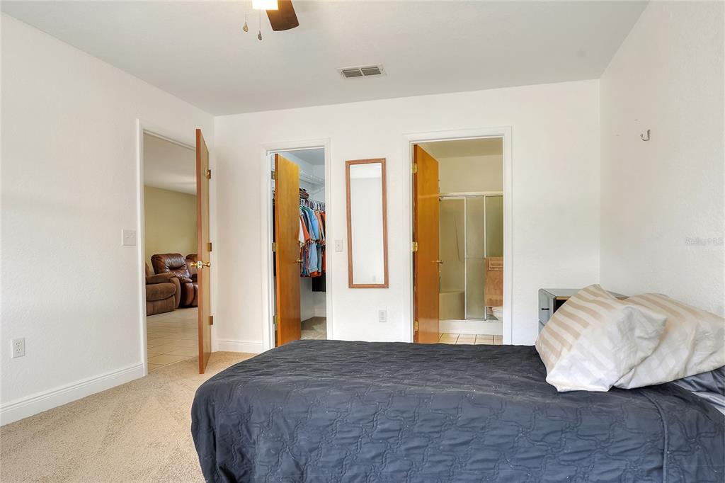 4846 Knights Station Road Lakeland, FL 33810 - Photo 23 of 49 a bedroom with a bed and a walk in closet