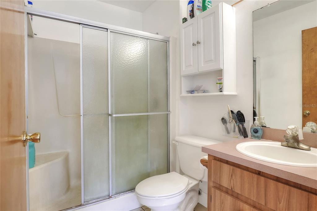 4846 Knights Station Road Lakeland, FL 33810 - Photo 24 of 49 a bathroom with a granite countertop sink toilet and shower
