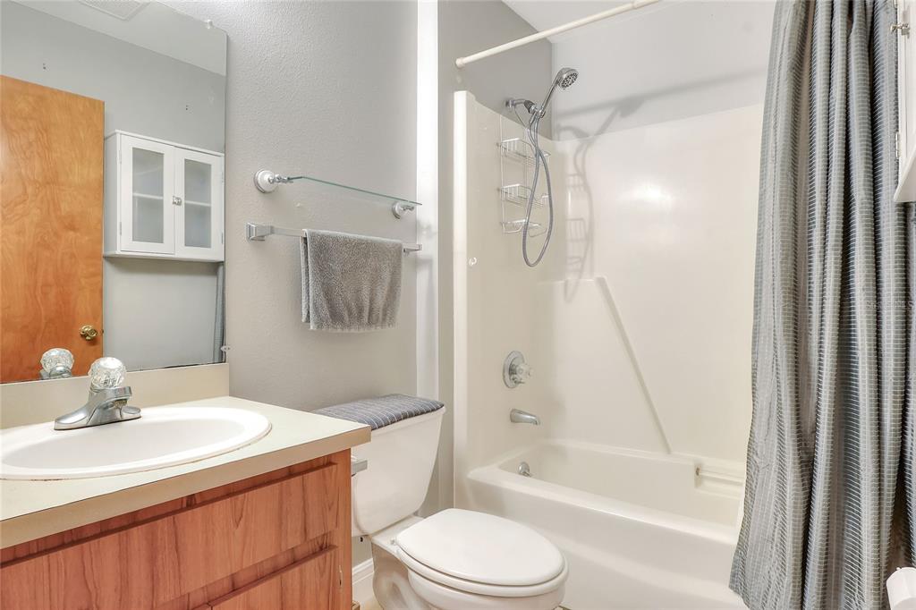 4846 Knights Station Road Lakeland, FL 33810 - Photo 26 of 49 a bathroom with a granite countertop sink toilet and shower