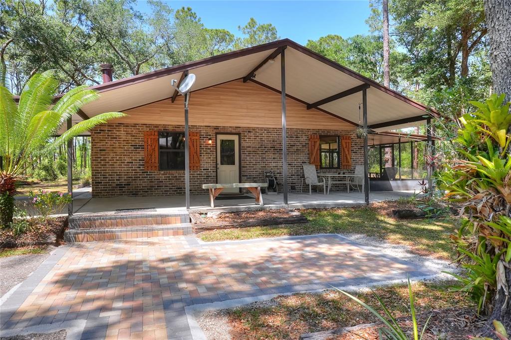 4846 Knights Station Road Lakeland, FL 33810 - Photo 32 of 49 a view of a house with backyard porch and sitting area