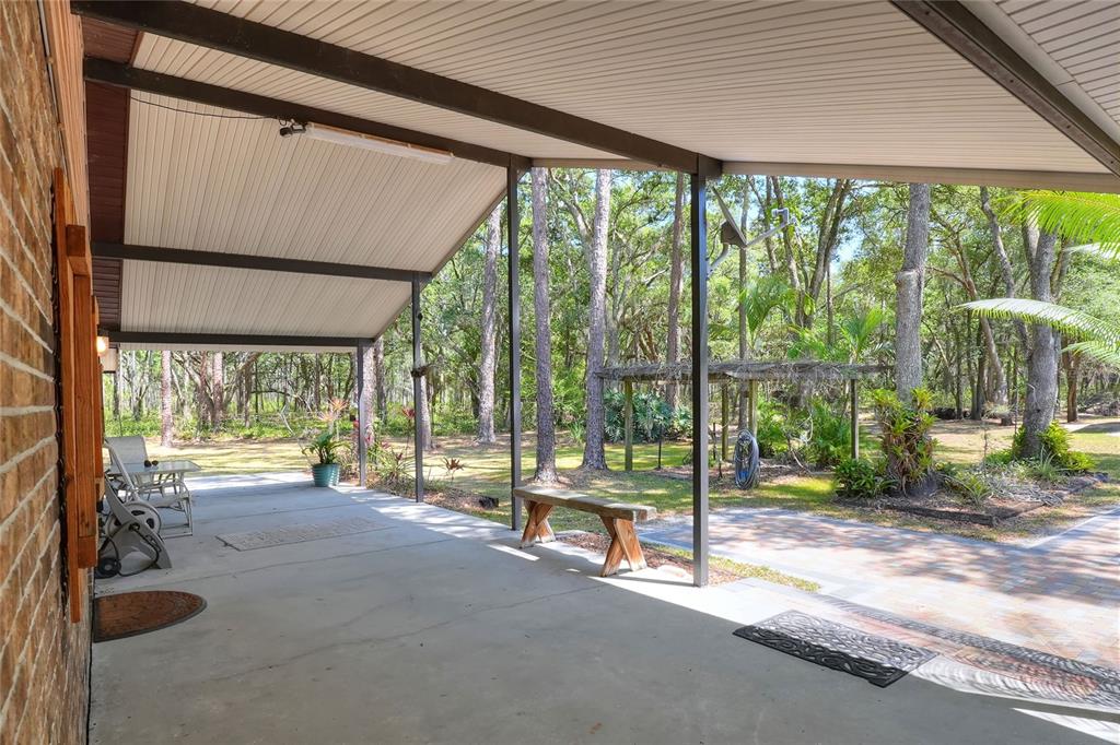 4846 Knights Station Road Lakeland, FL 33810 - Photo 33 of 49 a view of a porch with chairs and floor to ceiling window