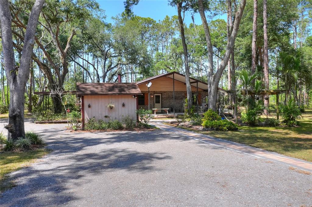 4846 Knights Station Road Lakeland, FL 33810 - Photo 37 of 49 a front view of a house with a yard and trees