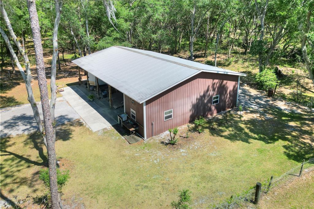 4846 Knights Station Road Lakeland, FL 33810 - Photo 38 of 49 a backyard of a house with large trees and plants