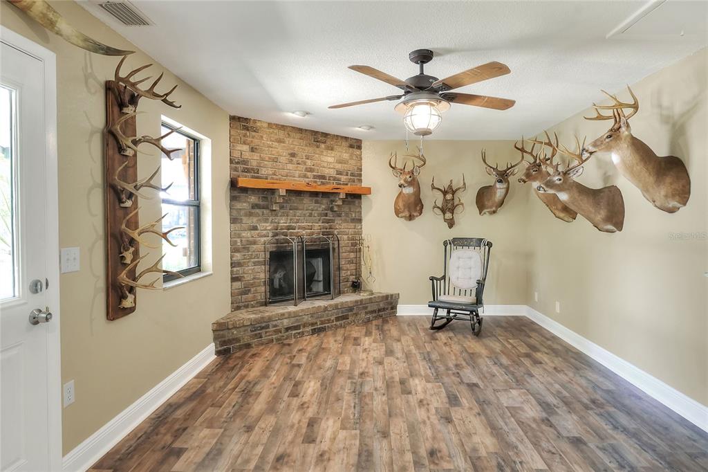 4846 Knights Station Road Lakeland, FL 33810 - Photo 10 of 49 a living room with furniture and a fireplace