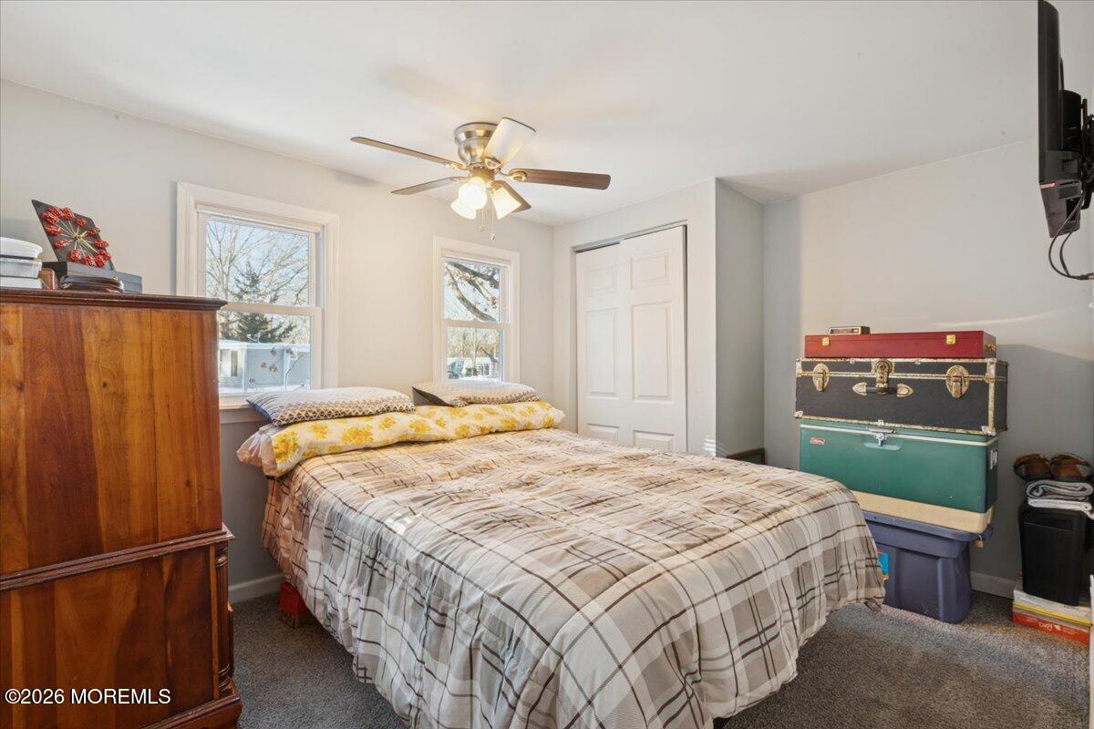 a bedroom with a bed dresser and a window