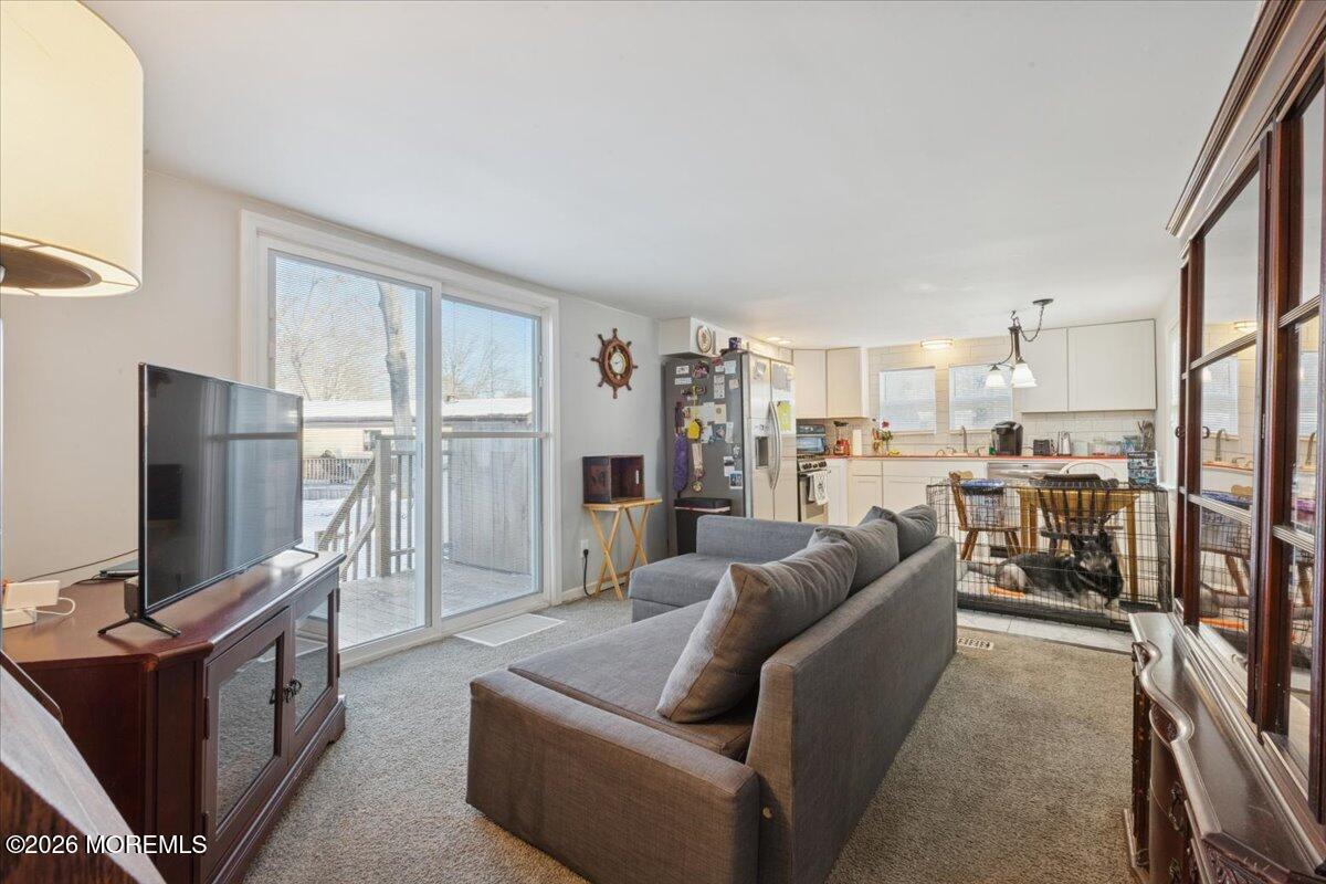 57 Roberts Road Toms River, NJ 08755 - Photo 11 of 14 a living room with furniture a flat screen tv and kitchen view