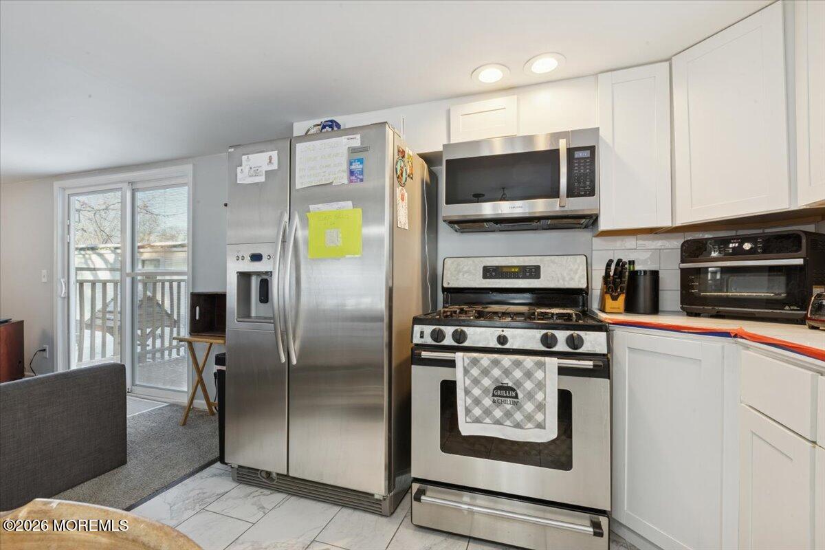57 Roberts Road Toms River, NJ 08755 - Photo 13 of 14 a kitchen with stainless steel appliances granite countertop a refrigerator a stove top oven a sink and dishwasher