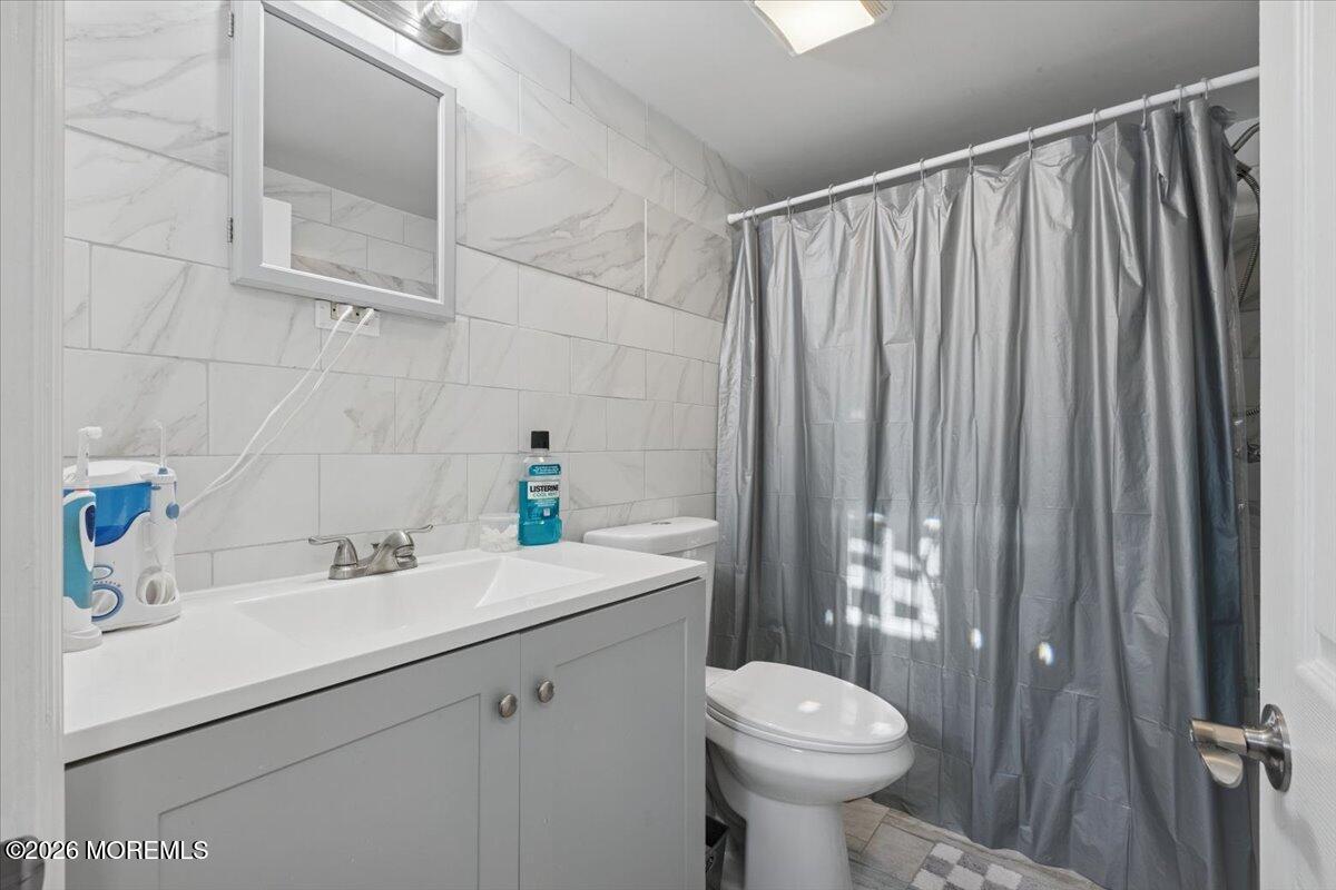 57 Roberts Road Toms River, NJ 08755 - Photo 2 of 14 a bathroom with a sink toilet and shower