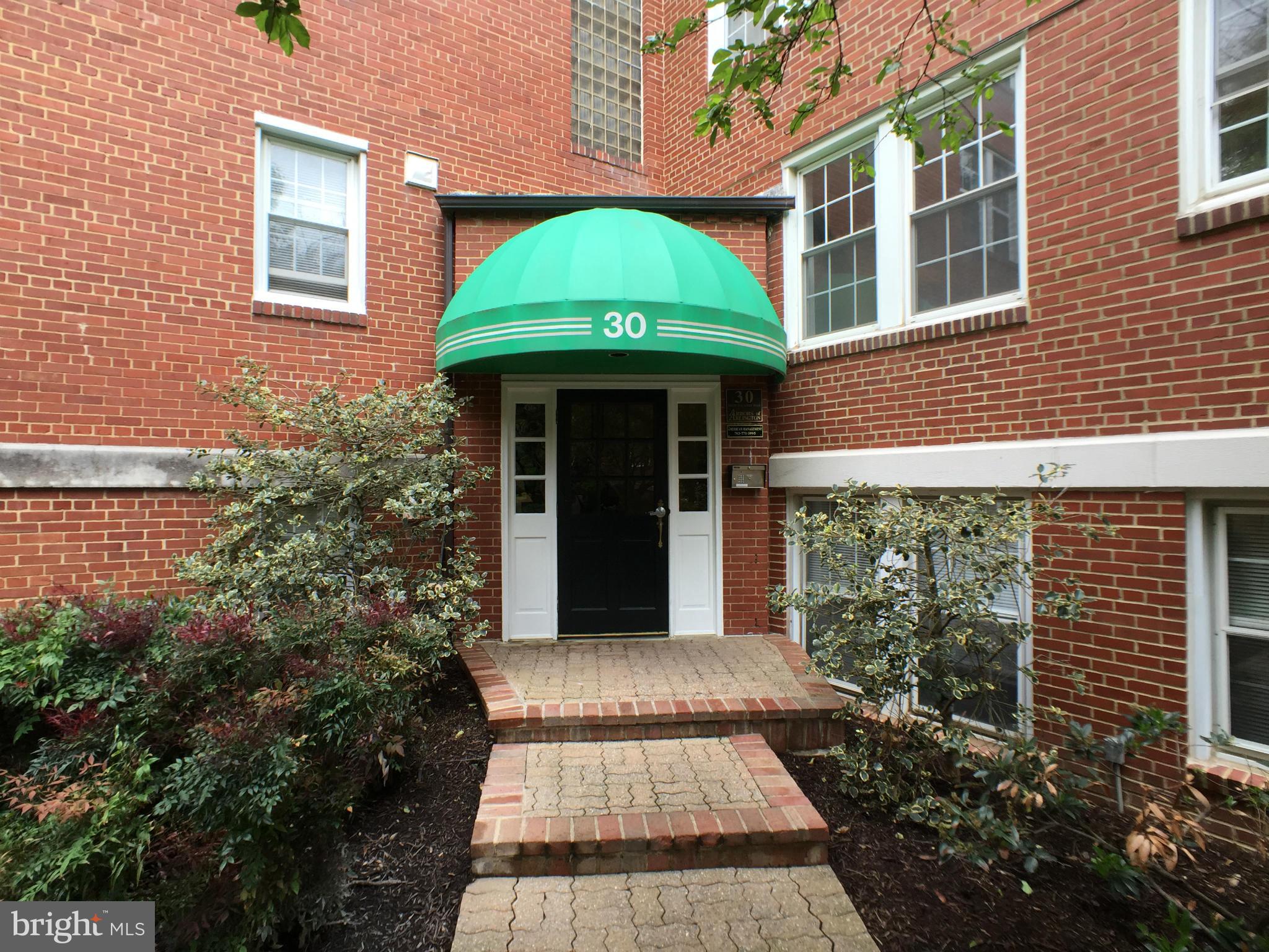 30 South Old Glebe Road, Unit 302E Arlington, VA 22204 - Photo 16 of 21 a front view of a house with a garden