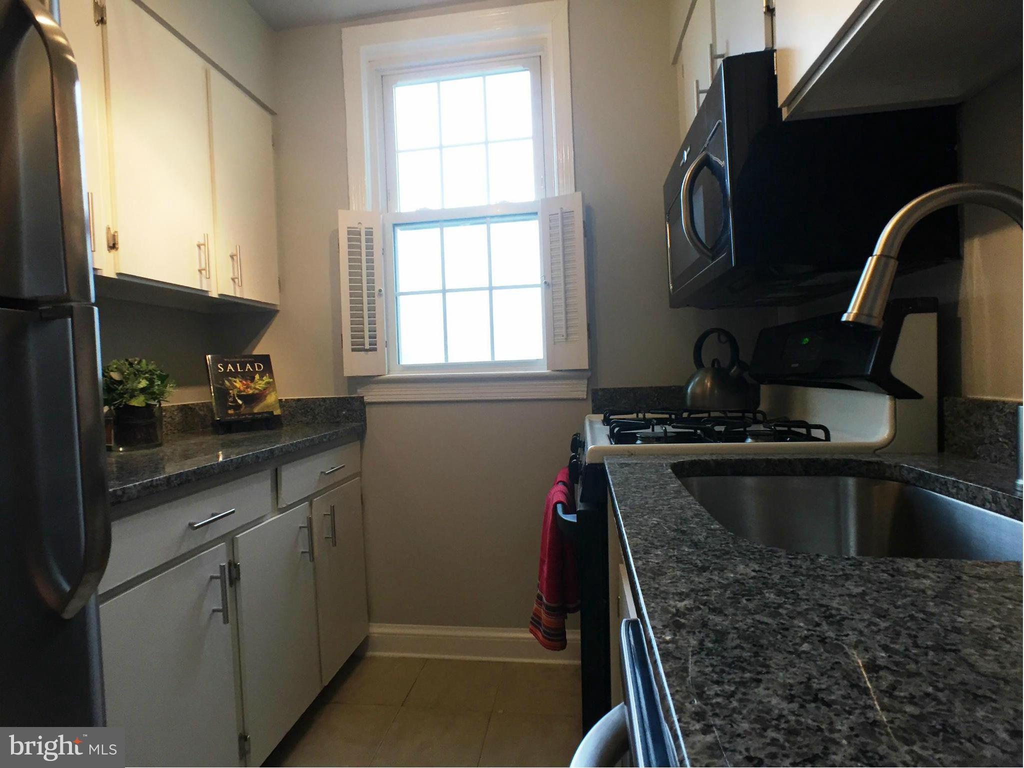 30 South Old Glebe Road, Unit 302E Arlington, VA 22204 - Photo 4 of 21 a kitchen with a sink appliances and cabinets