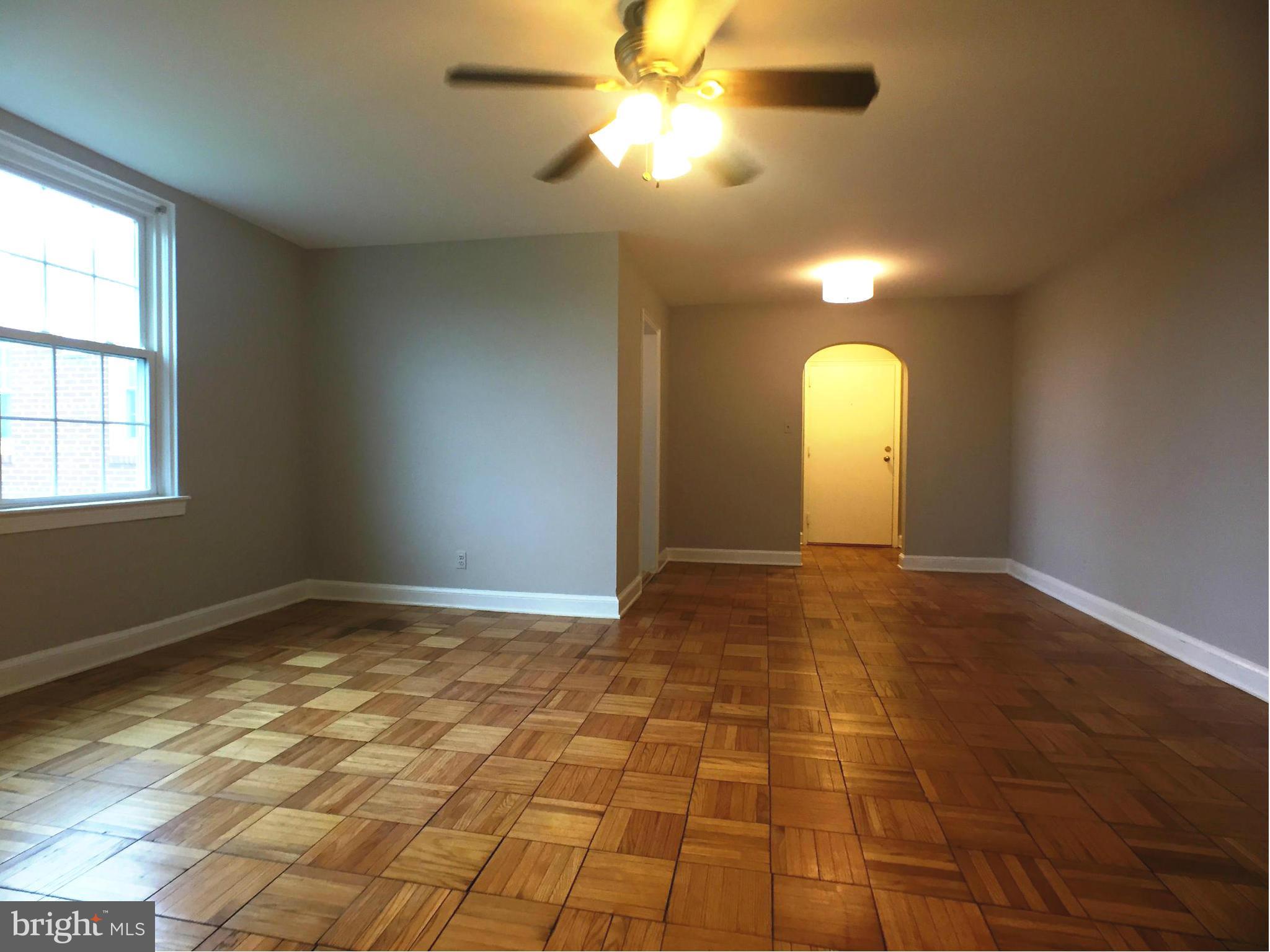 30 South Old Glebe Road, Unit 302E Arlington, VA 22204 - Photo 5 of 21 a view of an empty room and window and chandelier fan