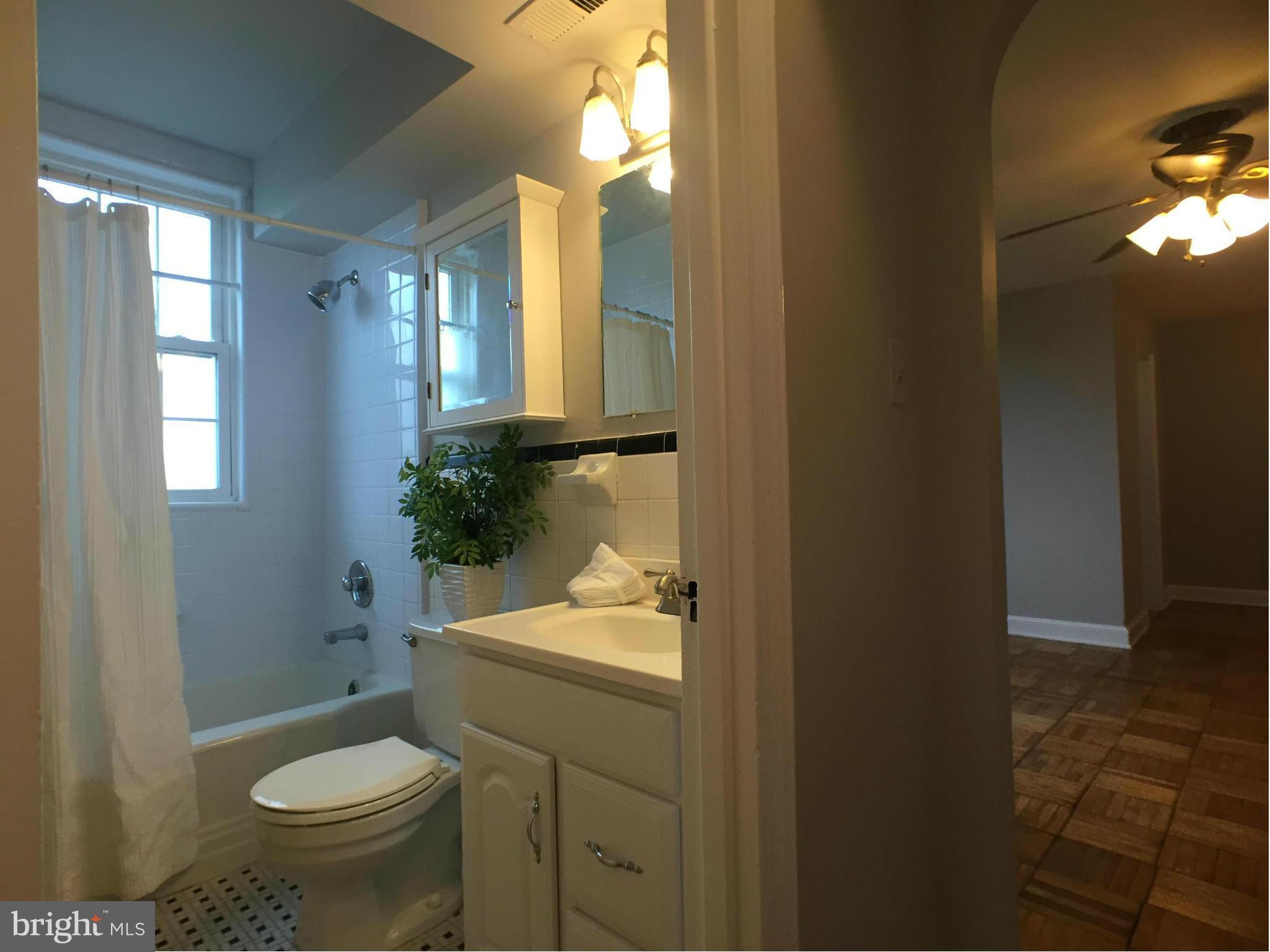 30 South Old Glebe Road, Unit 302E Arlington, VA 22204 - Photo 6 of 21 a bathroom with a sink toilet and a mirror