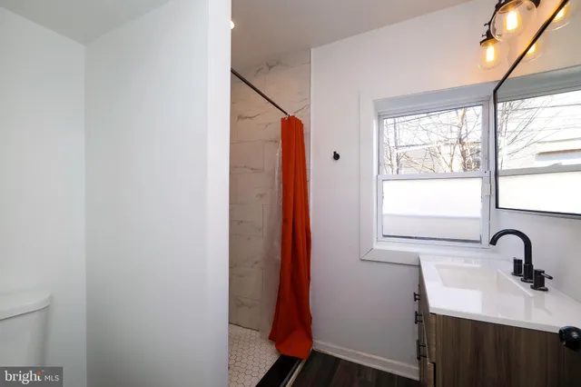 a bathroom with a sink and a window