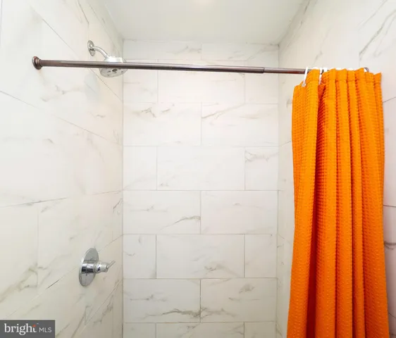 a bathroom with a shower and a shower curtain