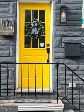 a view of front door of house and car parked