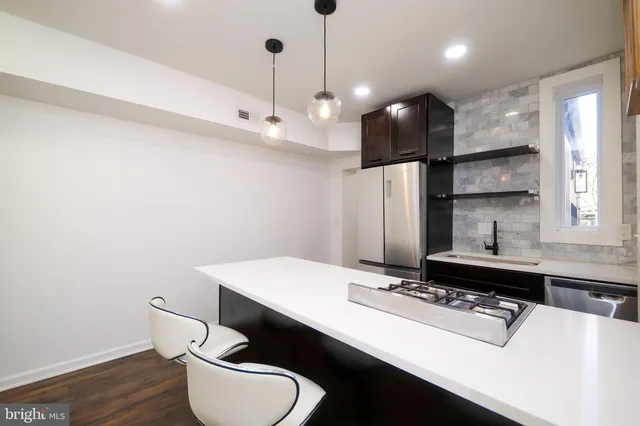 a bathroom with a sink a toilet a mirror and shower