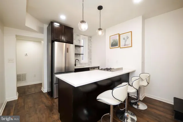 a large kitchen with a table and chairs