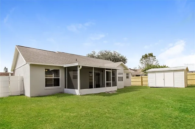 a view of a house with a backyard