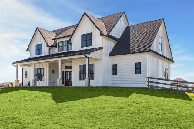 a view of a house with a yard and deck