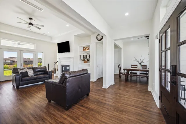 a living room with furniture and a wooden floor