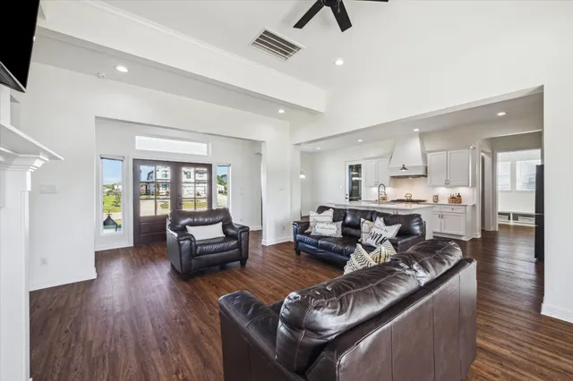 a living room with furniture and a wooden floor