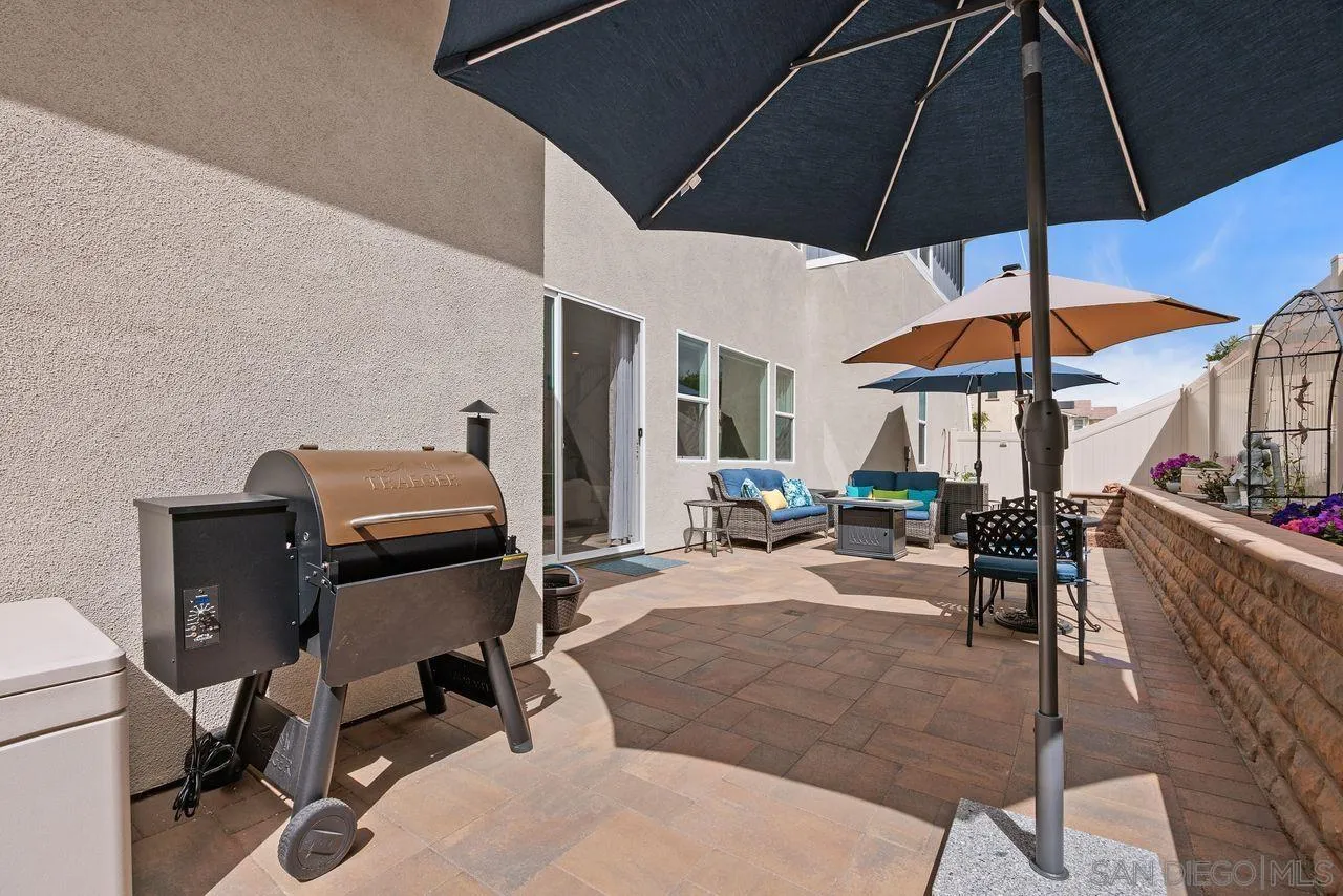 565 Townsend Way San Marcos, CA 92078 - Photo 26 of 33 a view of a patio with table and chairs under an umbrella
