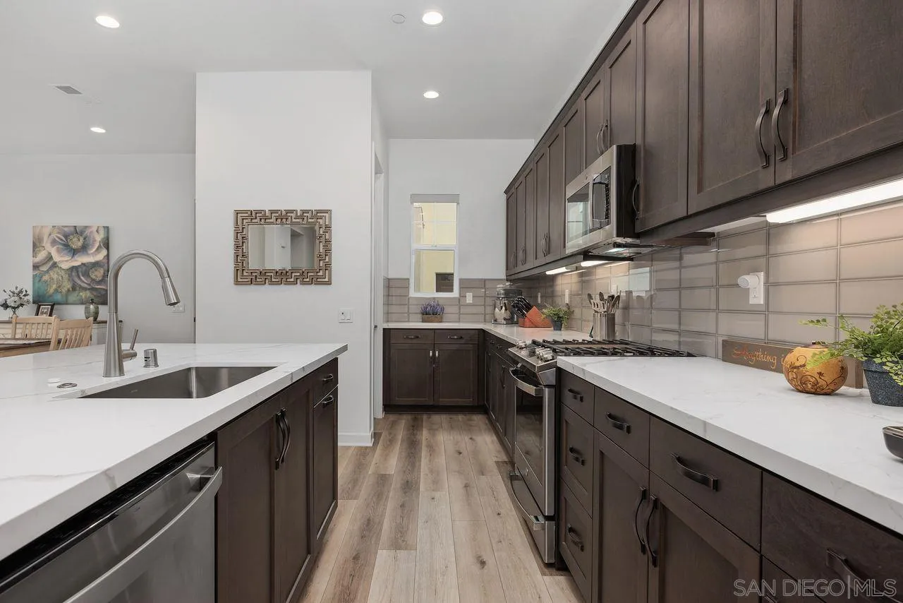 565 Townsend Way San Marcos, CA 92078 - Photo 8 of 33 a kitchen with a sink stove and cabinets
