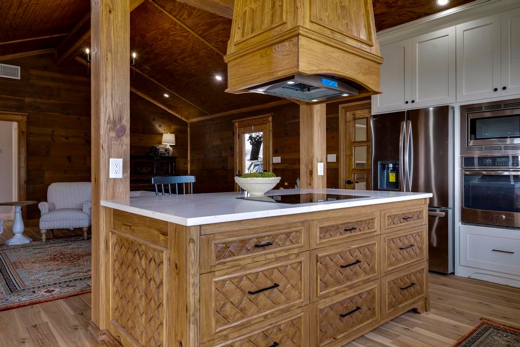 111 Stoney Hills Road Center Point, TX 78010 - Photo 25 of 61 a kitchen with a cabinets and chandelier