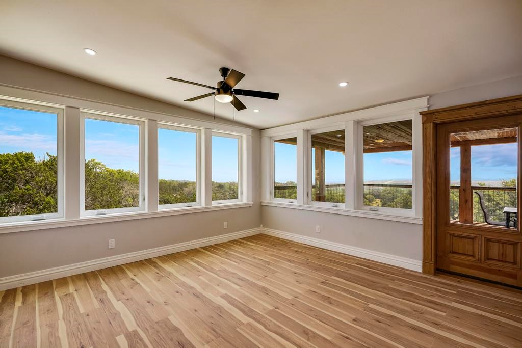 111 Stoney Hills Road Center Point, TX 78010 - Photo 30 of 61 a view of empty room with wooden floor and fan