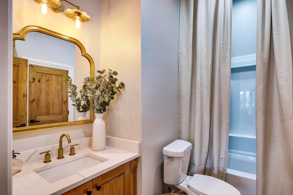 111 Stoney Hills Road Center Point, TX 78010 - Photo 39 of 61 a bathroom with a sink vanity mirror and toilet