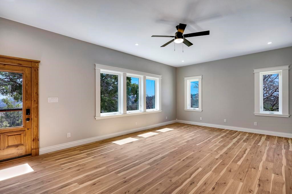 111 Stoney Hills Road Center Point, TX 78010 - Photo 40 of 61 a view of an empty room with wooden floor and a window