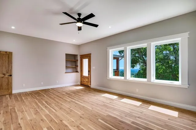 a view of empty room with large windows