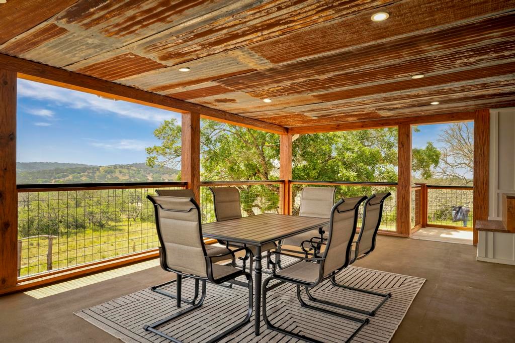 111 Stoney Hills Road Center Point, TX 78010 - Photo 48 of 61 a view of a dining room with furniture window and outside view