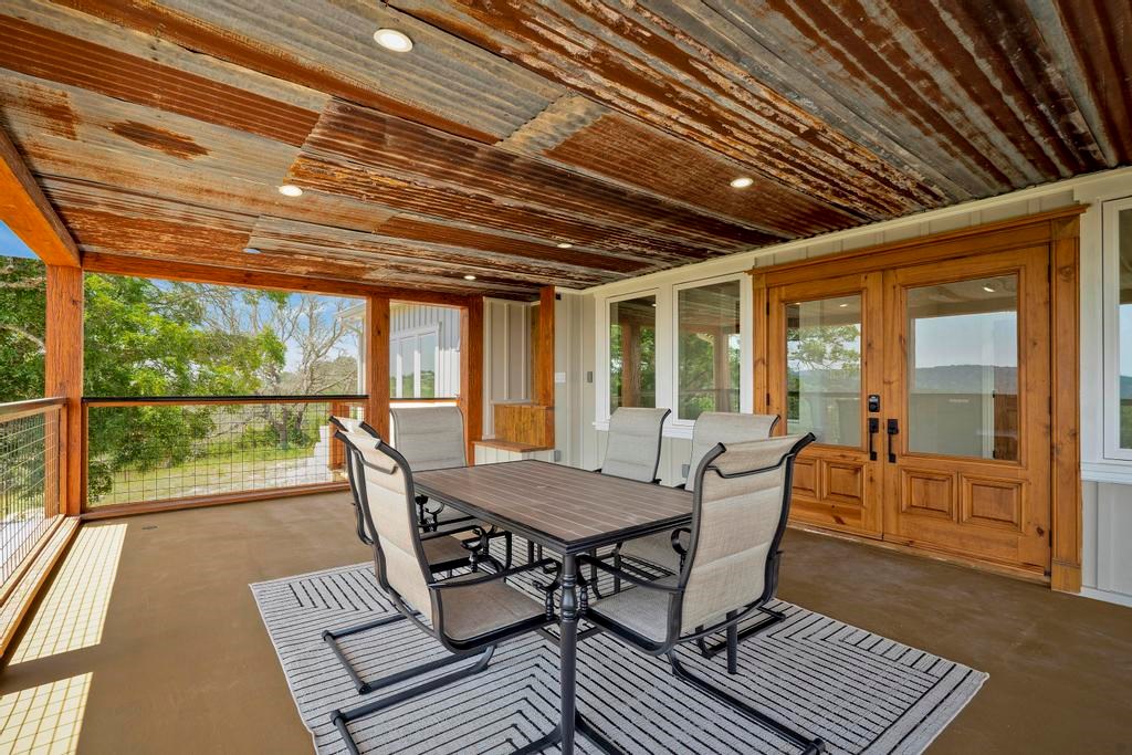 111 Stoney Hills Road Center Point, TX 78010 - Photo 49 of 61 a view of a patio with table and chairs