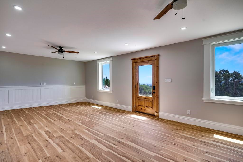 111 Stoney Hills Road Center Point, TX 78010 - Photo 53 of 61 wooden floor in an empty room with a window
