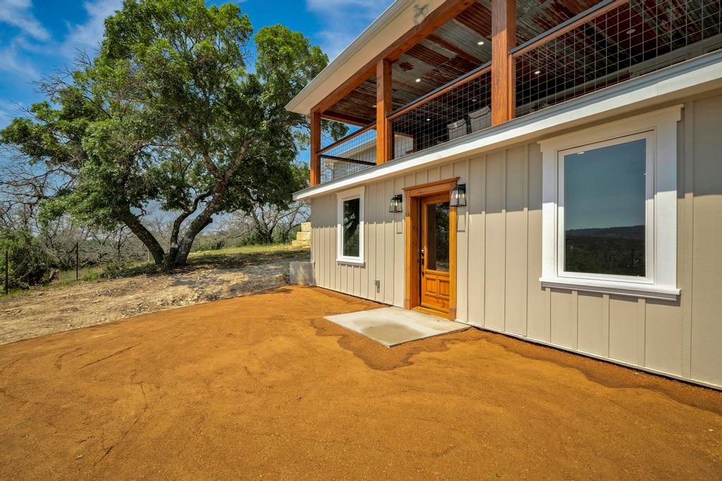 111 Stoney Hills Road Center Point, TX 78010 - Photo 56 of 61 a front view of a house with a yard