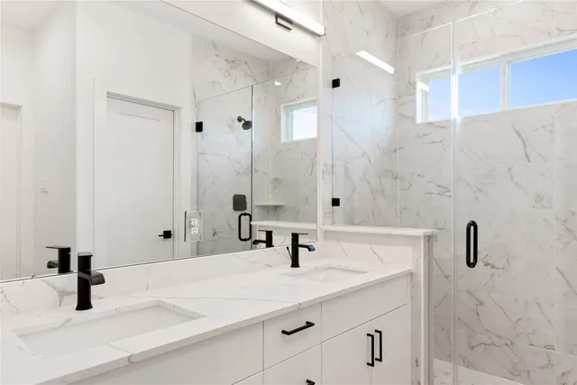a bathroom with a sink double vanity and a mirror