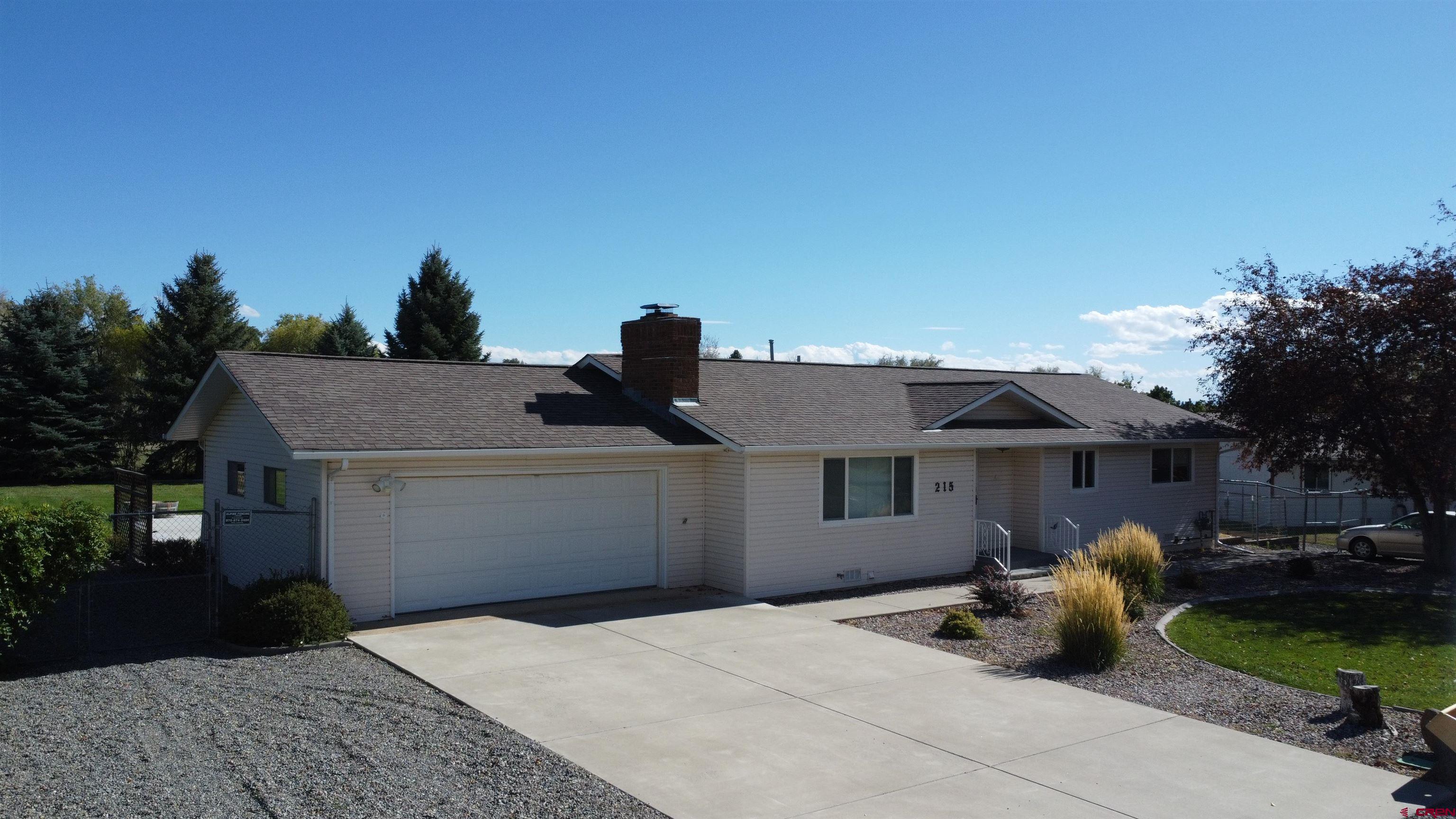 215 Southwest 8th Circle Cedaredge, CO 81413 - Photo 2 of 30 a front view of a house with garden