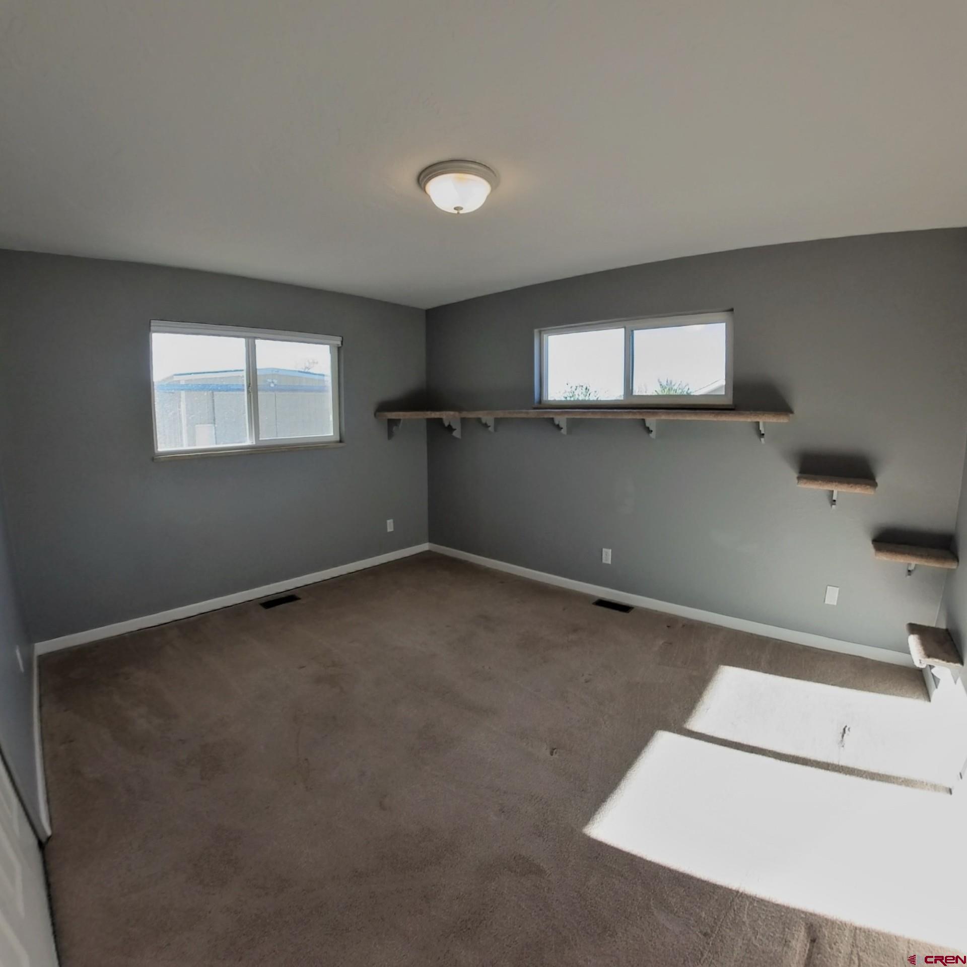 215 Southwest 8th Circle Cedaredge, CO 81413 - Photo 21 of 30 an empty room with windows