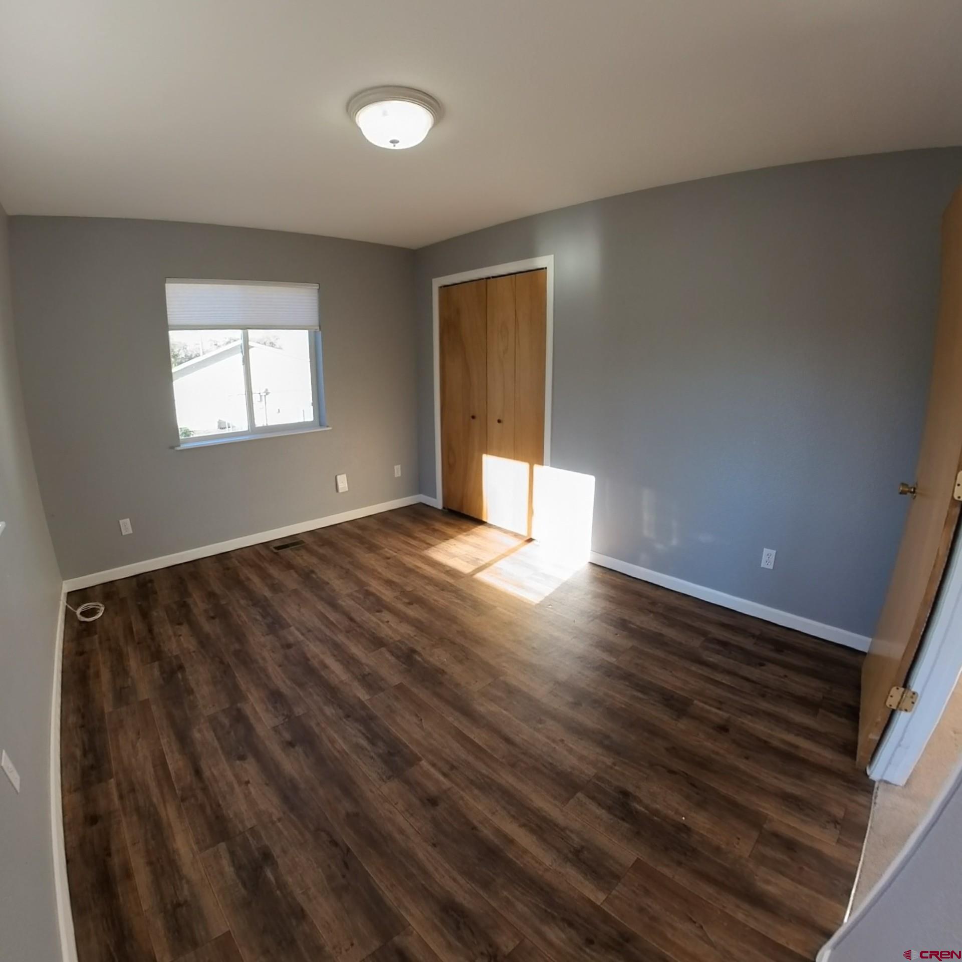 215 Southwest 8th Circle Cedaredge, CO 81413 - Photo 24 of 30 a view of an empty room with wooden floor and a window