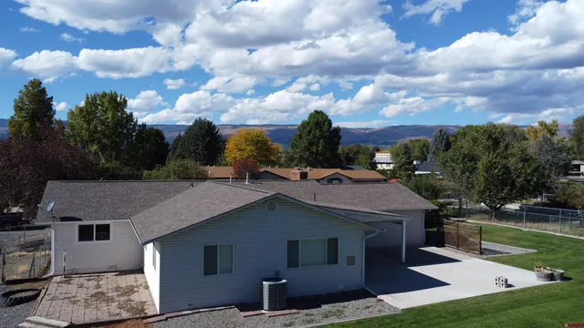 a aerial view of a house next to a yard