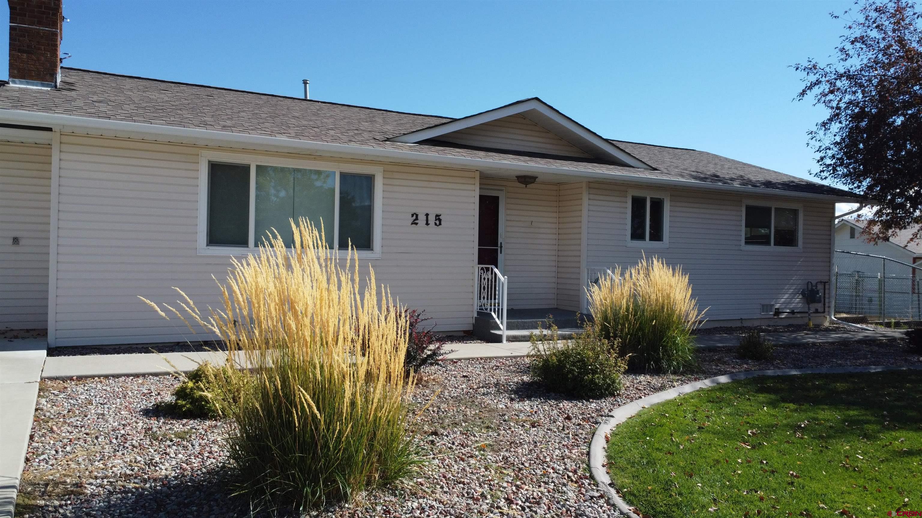 215 Southwest 8th Circle Cedaredge, CO 81413 - Photo 4 of 30 a front view of a house with garden