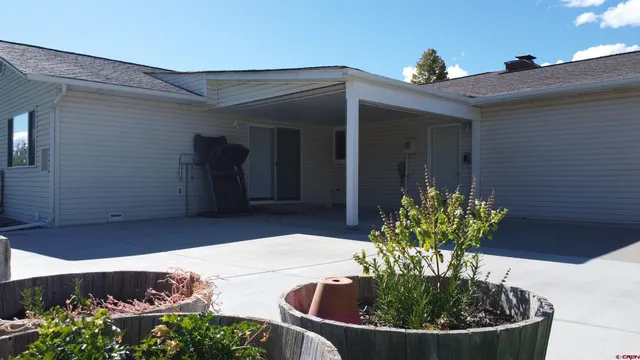 a view of a house with a flower in a yard