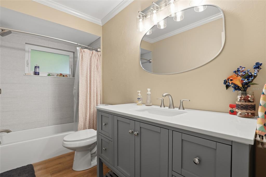 4576 Bliss Road Sarasota, FL 34233 - Photo 21 of 40 a bathroom with a sink a toilet and a mirror